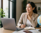 Filipino professional preparing for overseas career opportunities using a laptop, passport, and travel resources before applying for international employment.