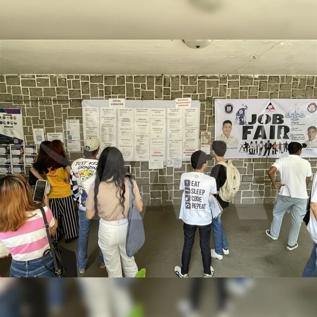 Job seekers attending a recruitment job fair hosted by an accredited Philippine recruitment agency offering overseas employment opportunities.